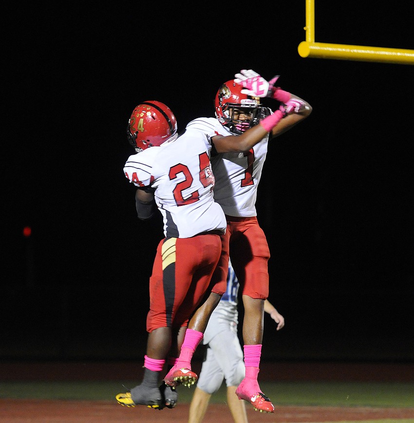 Jaz Mongeon and Blair Perry celebrate following Mongeonâ€™s 30-yard touchdown run in the second quarter.