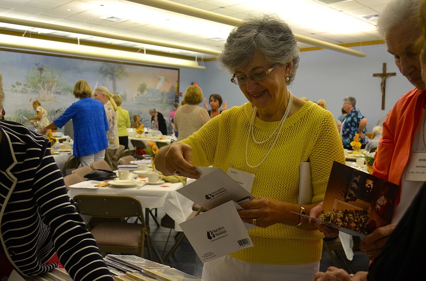 Maria Sangiorgio chooses which dog-covered greeting card she wants to take home