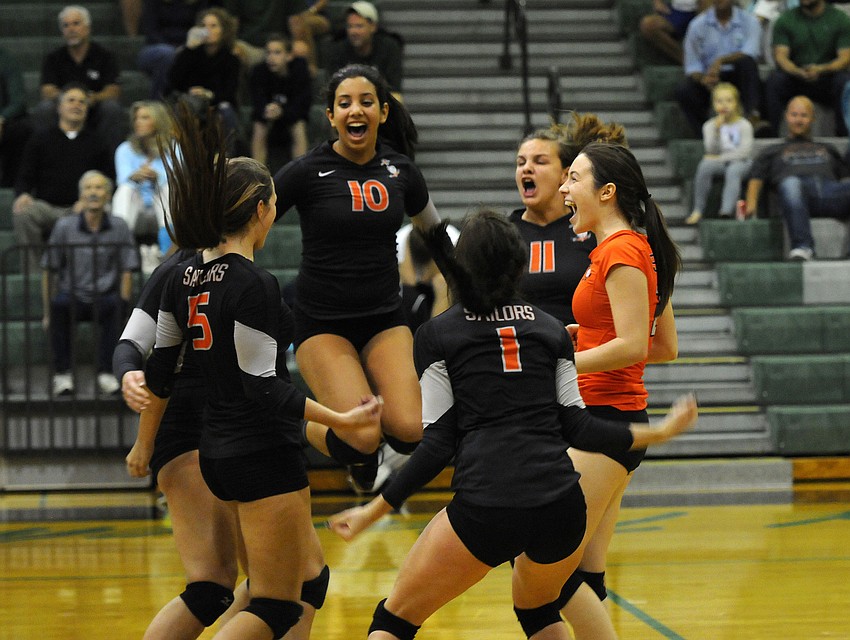 The Sarasota High volleyball team celebrates following its 26-24 victory over Lakewood Ranch in the second set. It was the first time the Lady Sailors had won a set against the Lady Mustangs all season.