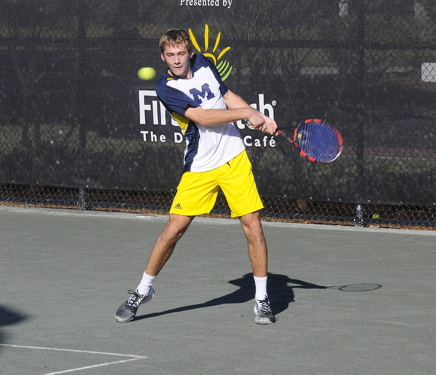 Michiganâ€™s Alex Knight returns a serve during his doubles match Nov. 7.