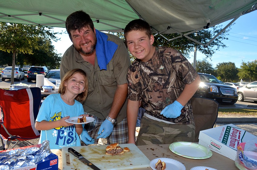 The Severs family â€” Karoline, Joe and Cameron â€” serve up their freshly-made burgers.