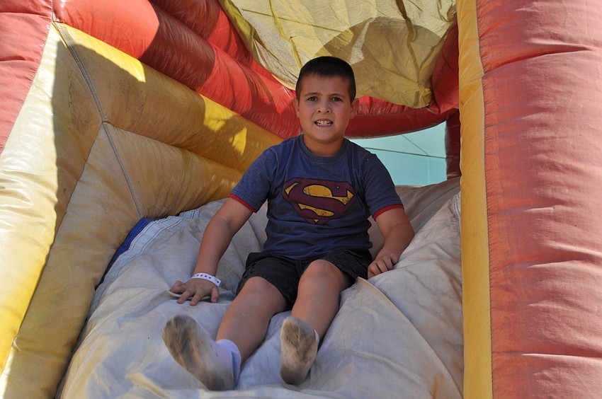 Johnny Sugalski, 9, slides down an inflatable.