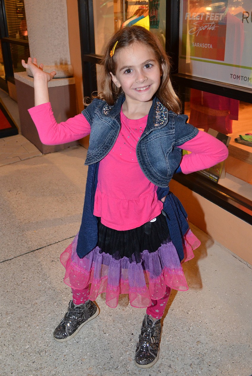 Liza Collier shows off her pink outfit for the flamingo fantasyland themed holiday stroll.