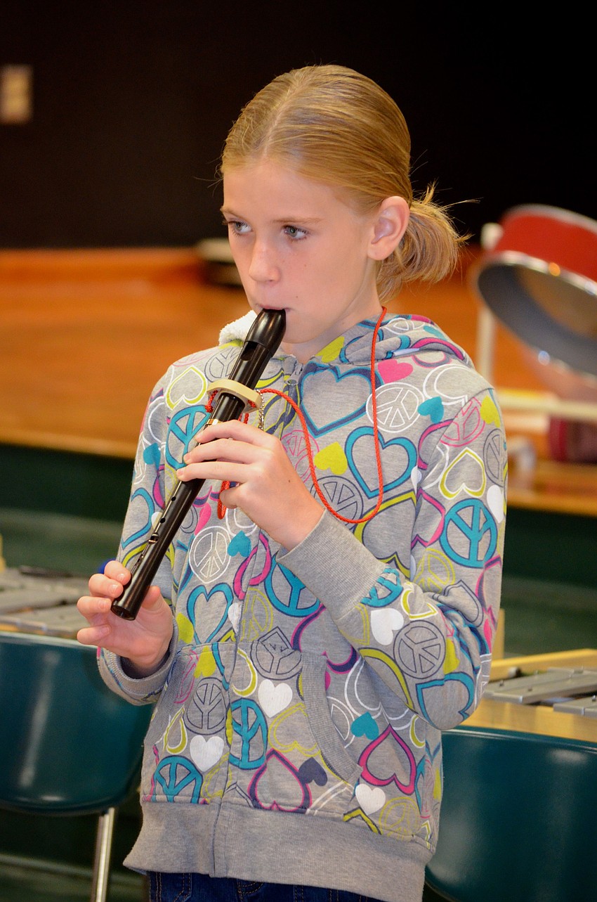 Norah Secord plays her recorder during a holiday song.