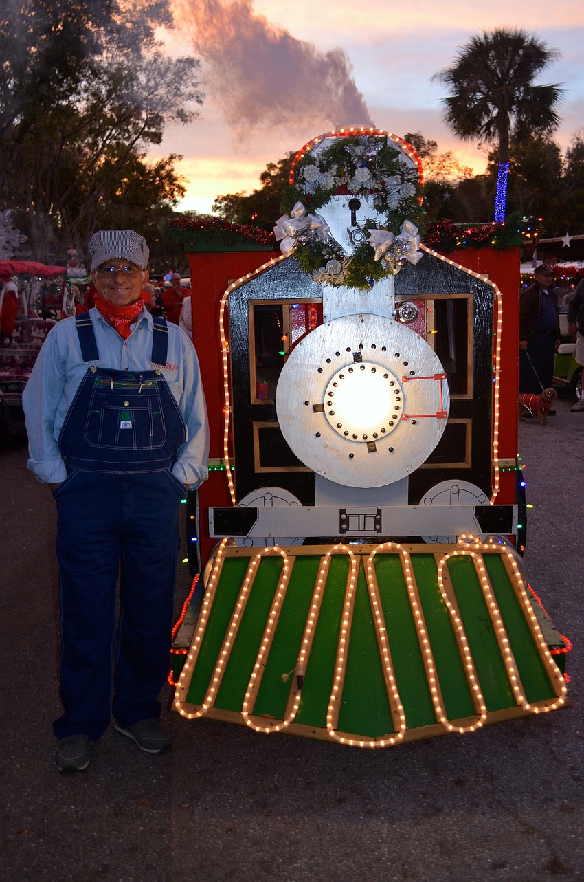 Buddy Brunson plays a conductor beside his train.