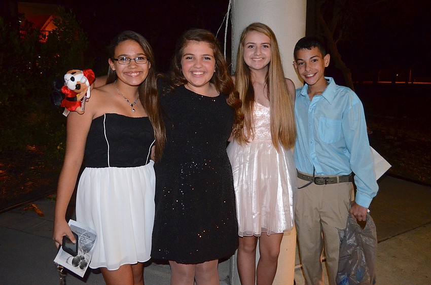 Bella Sellmer, Brighid Traugutt, Hannah Pierce and Joseph Gigliotti wear matching smiles.