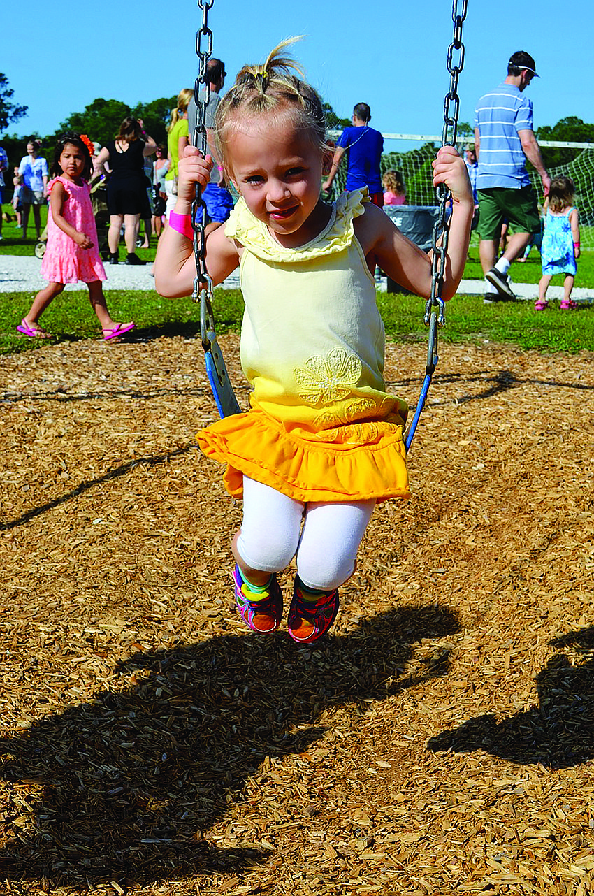 Gabbie Hotaling, 5, swings while she waits for the egg hunt to begin at the Lakewood Ranch Eggstravaganza event April 12.