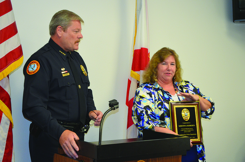 Retiring Longboat Key Police Detective Capt. Kristina Roberts, right, accepts a plaque from Police Chief Pete Cumming July 7, in a retirement ceremony that celebrated her 31 years of service to the department.