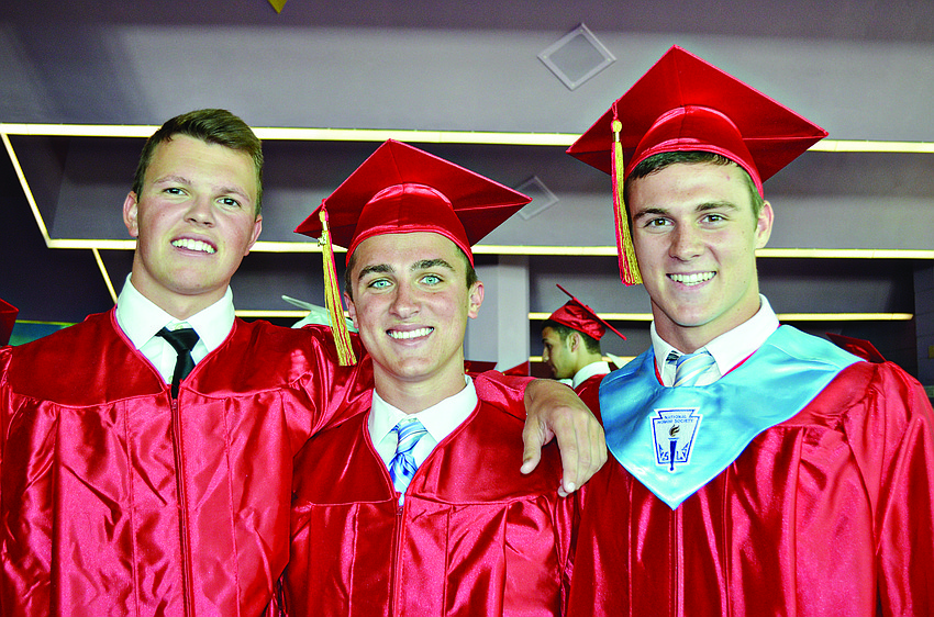 Cardinal Mooney seniors Clark Horne, Ross Bumgarner and Jonah Schopfer graduate with their classmates at the Van Wezel Performing Arts Hall.