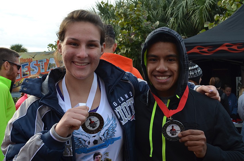 Cassandra Golenski and Manuel Montiel show off their medals from participating in the 2nd annual Andrew Monroe Memorial 5K Walk/Run.
