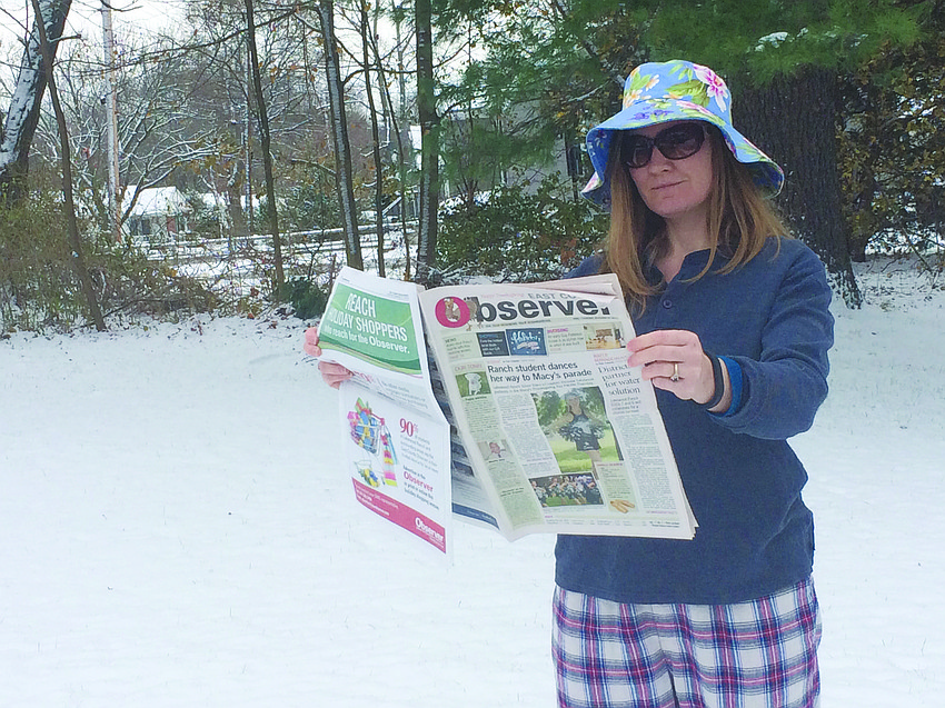 NORTHERN EXPOSURE. Marthe Knight catches up on her Observer news in cold, snowy Canton, Mass.