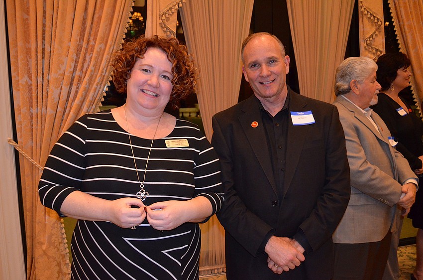 Eva Rey and Jeff Reeves show off their pins for three years of service.