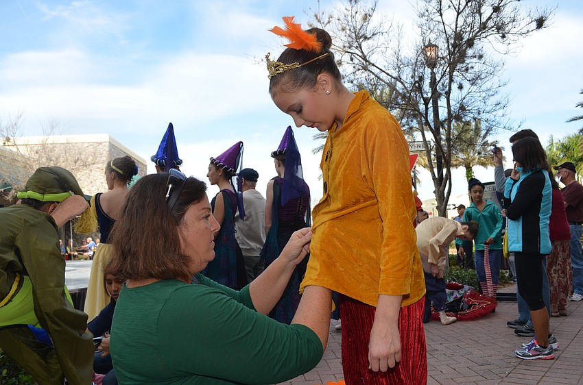 Anne Walsh helps her daughter, Abbey, get dressed for her next performance.
