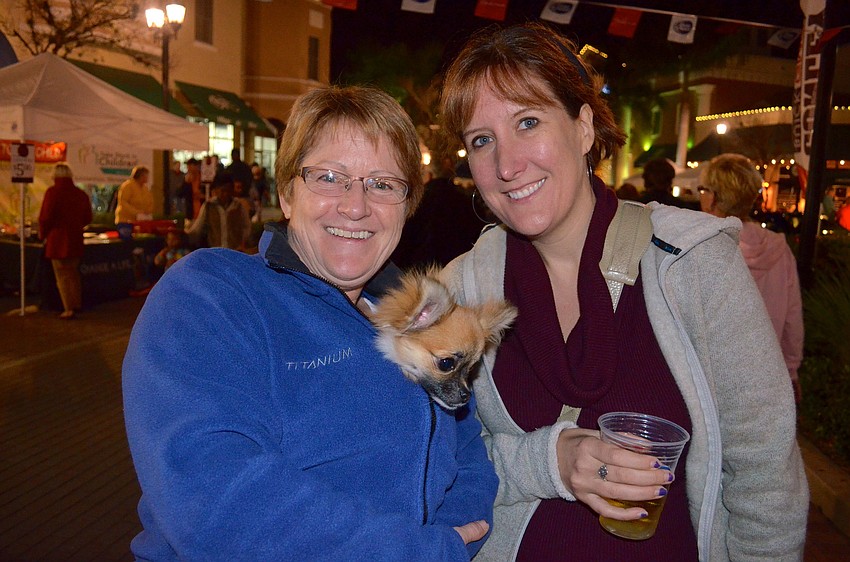 Maureen Corristan and Jenny Marczynski keep Tessie warm as they comb Main Street for activities.