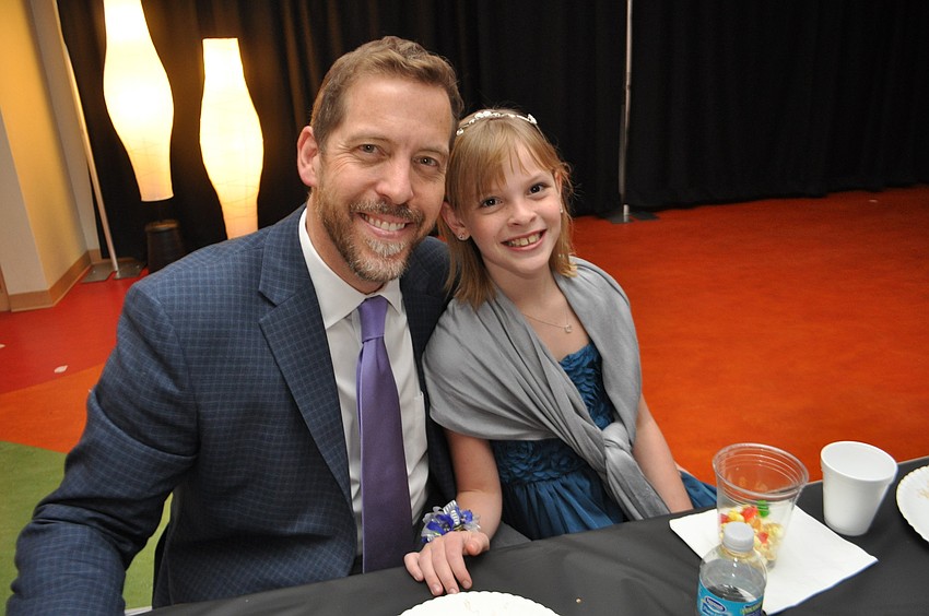 Mark Lewis attends with his daughter, Remy.