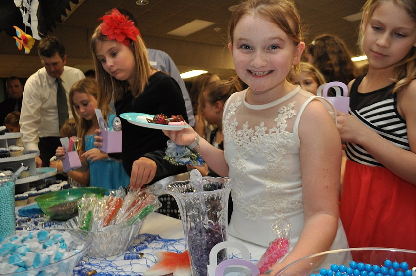 Jaxen McPheron, 8, loads up on candy.