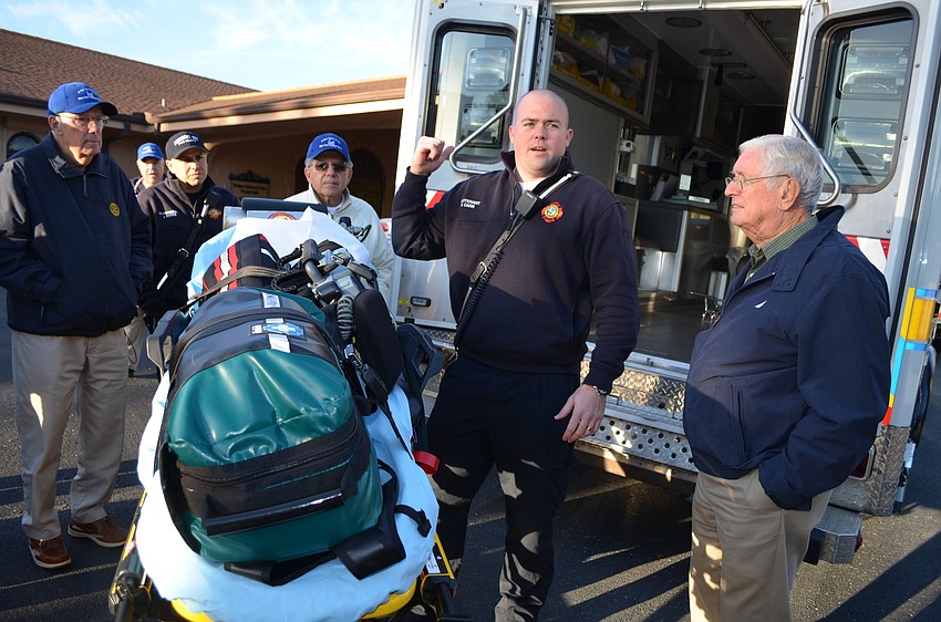 Lieutenant Bryan Carr shows club members first aid techniques the firefighters use.