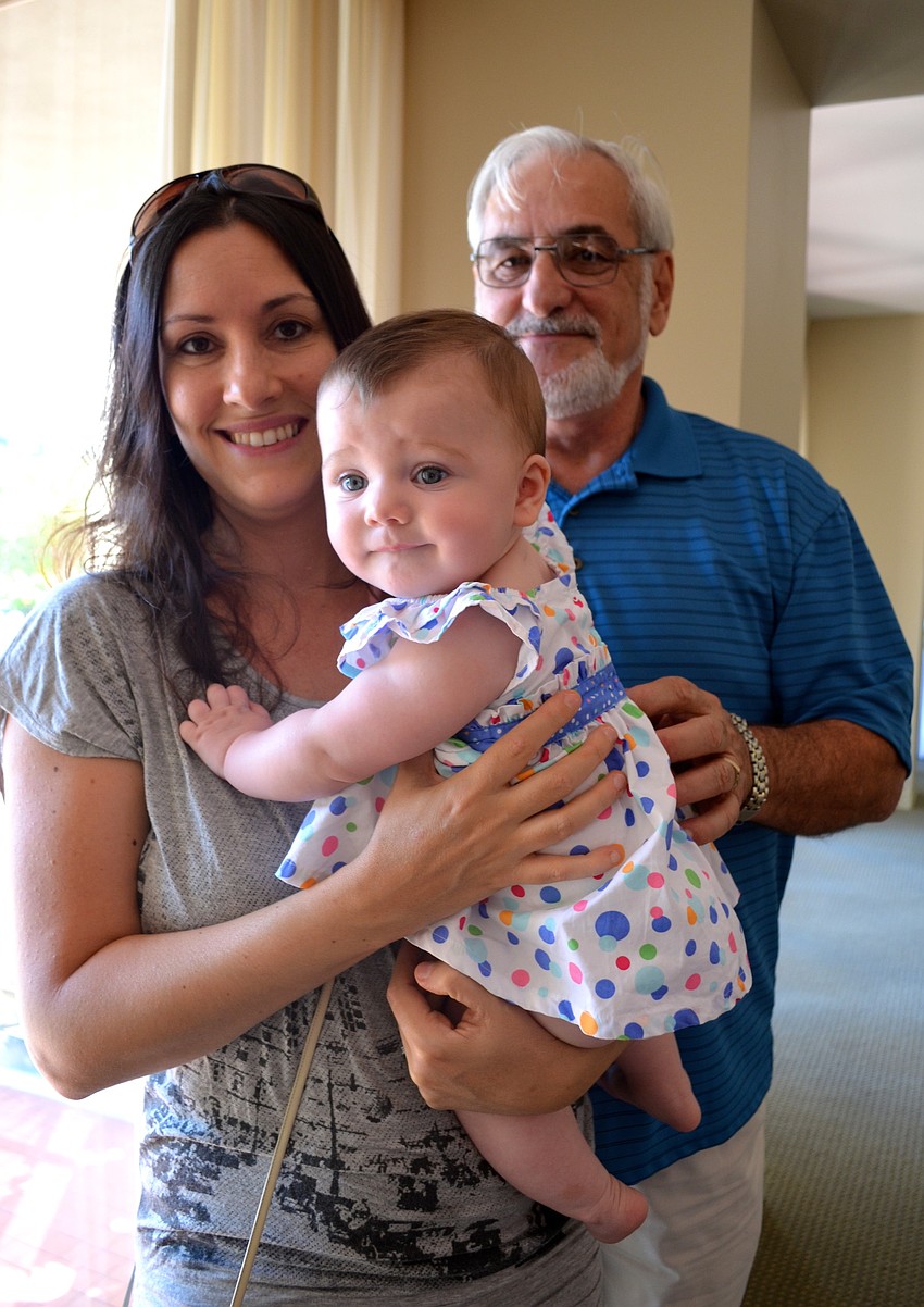 Alex Kennedy and her daughter, Mila, with Ray Burt