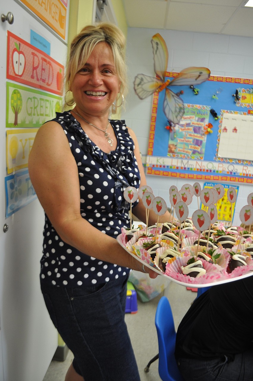 Teacher Michelle Ragni shares chocolate-covered strawberries, muffins and other treats with her students and their mothers.