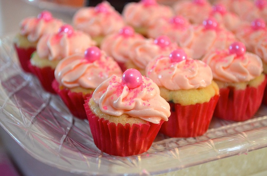 Attendees of the daddy-daughter dance snacked on pink frosted cupcakes and other snacks.