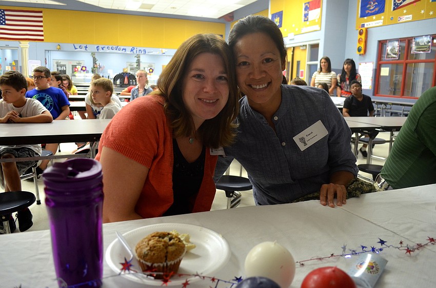 Donna Bolton and Sandy Severs snack on muffins and other breakfast foods.