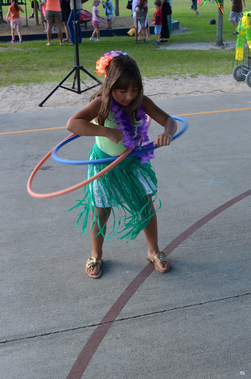 In her grass skirt, Stephanie Yalda shows off her hula-hoop skills.