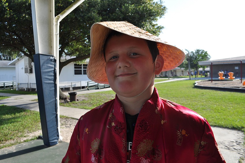 Bobby Vogelsong, 9, tries on a Chinese hat.