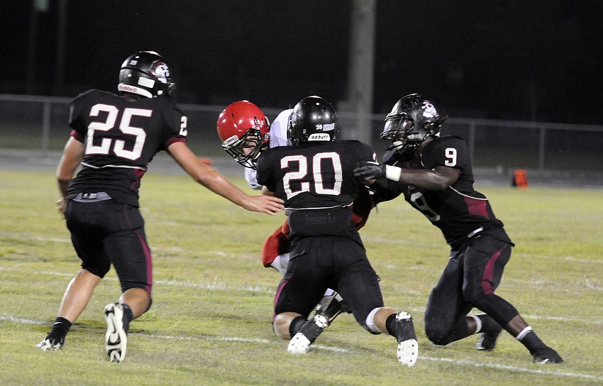 Braden River linebackers Zach Maugherman, Chase Balliette and JoJo Louis tackle Cardinal Mooneyâ€™s Alex Sobczak for a loss in the second half.