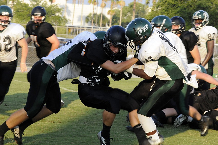 Sarasota running back Davis Gurr carries the ball for a short gain in the second quarter.