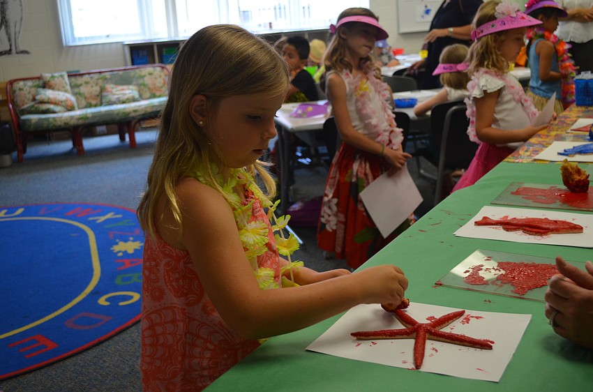 Emma Haskins makes a print of a sea creature.