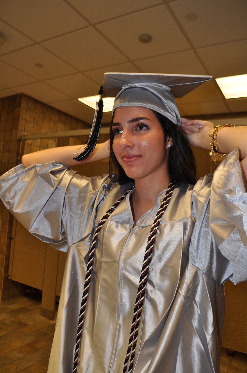 Gabriela Perez adjusts her cap.