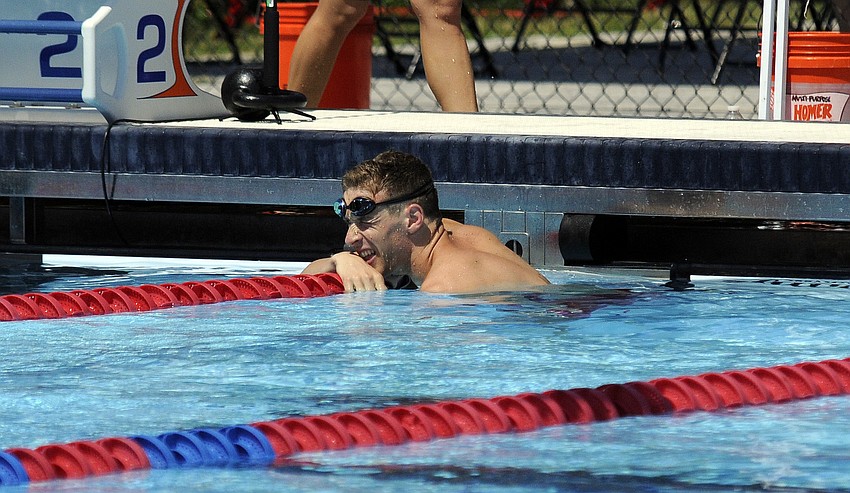 The United Statesâ€™ Nathan Schrimsher looks back at the scoreboard after winning heat 1 of the 200-meter freestyle mixed relay in 1 minute, 57.59 seconds.