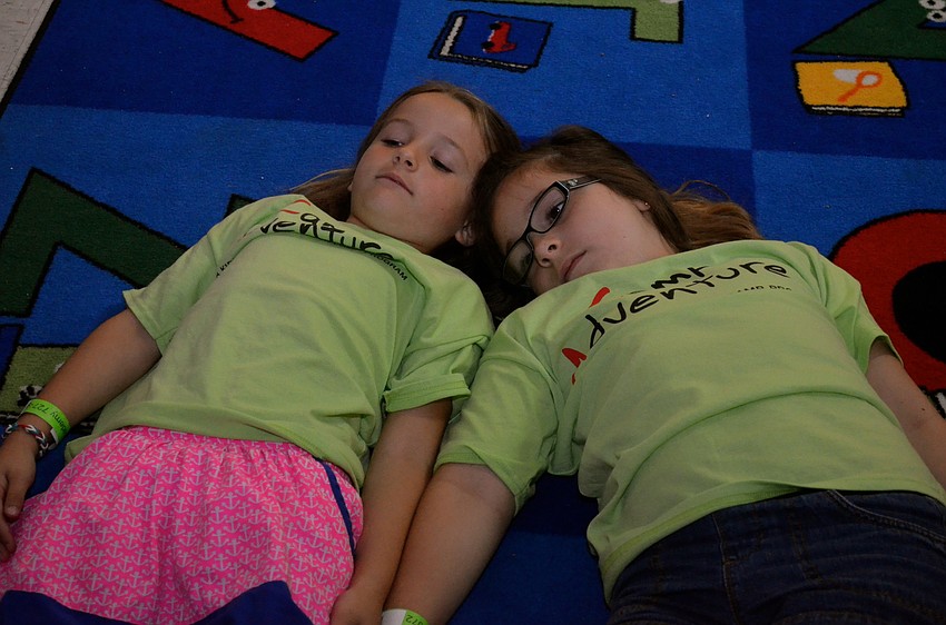 Seven-year-olds Olivia Degrave and Cayla Weins watch 