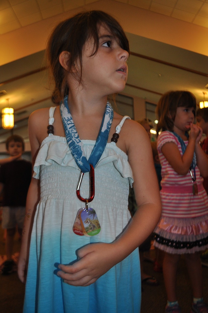 Gretta Bonifate, 5, performs motions to a worship song.