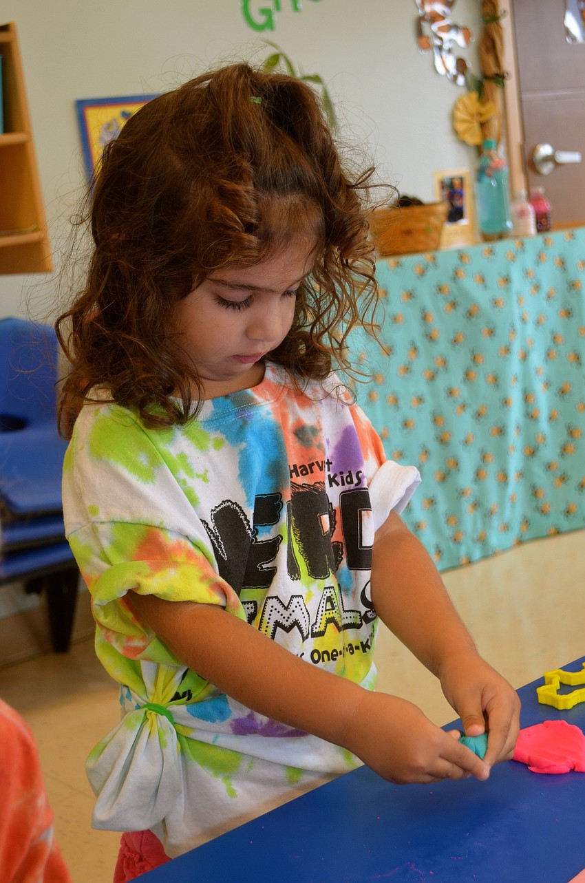 Three-year-old Haven Wood enjoys craft time.