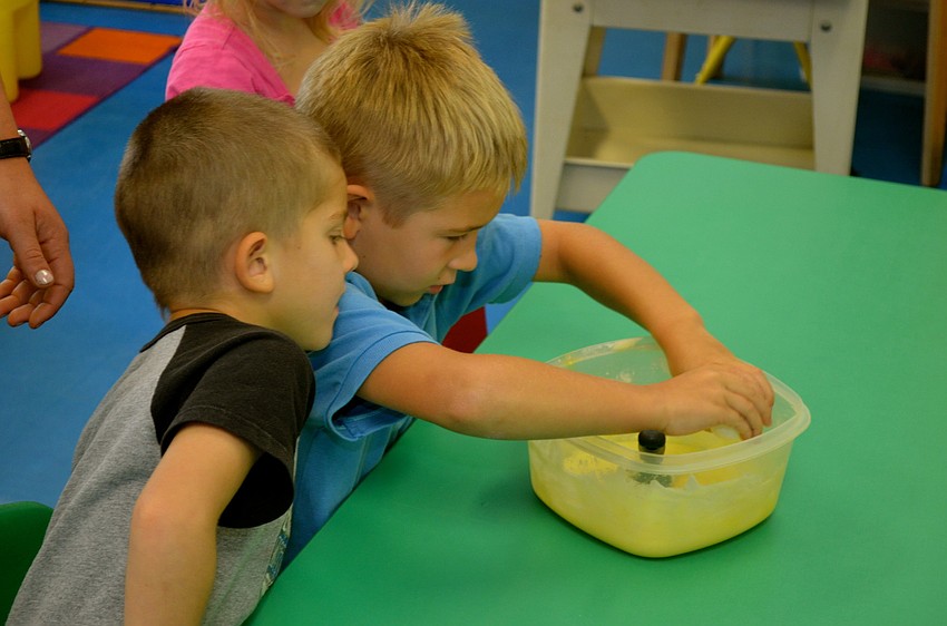 Brian Manns and Leo Bowers work together to crack an egg.