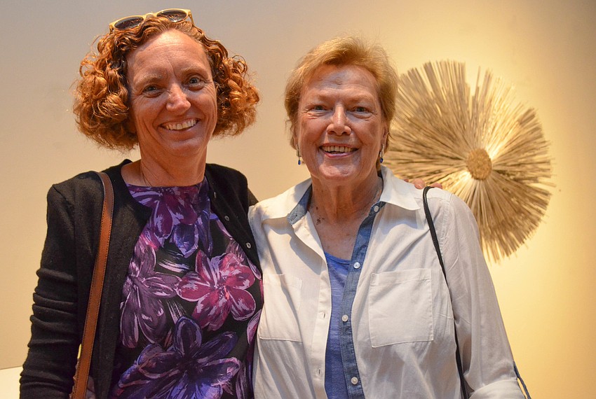 Andrea Seager and Peg Stone in front of Calvin Bryant's untitled piece