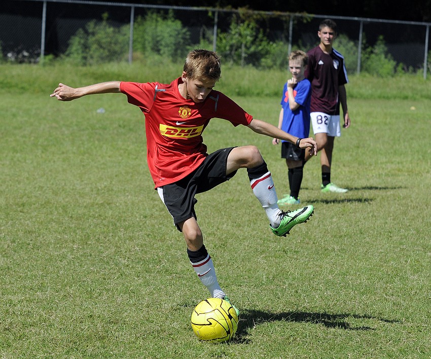 Twelve-year-old Calvin Drake secures the ball before heading toward the goal.