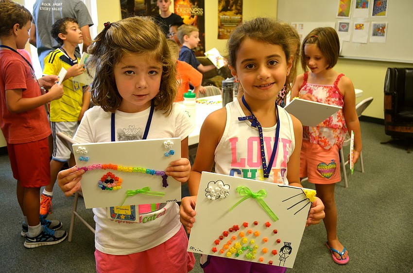 Hannah Leitzman and Olivia Ajrab show off the projects they created on Ireland day.