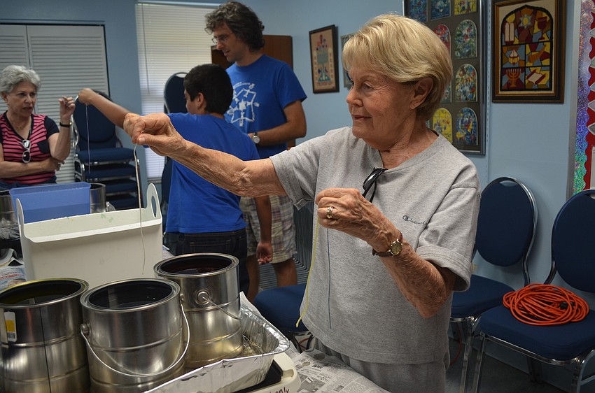 Sylvia Gross is the first to make a candle.