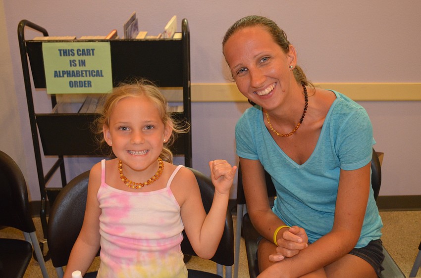 Karabeth Chatzistamatis signs the color yellow with mom, Tiffany.