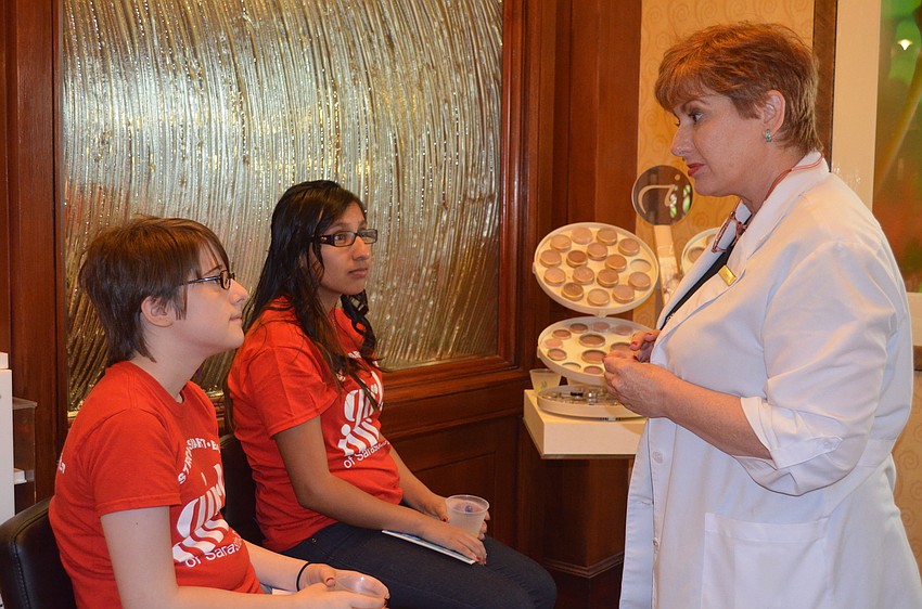 Veronica Holmes and Alex Perez learn about skincare with Carol Webster.