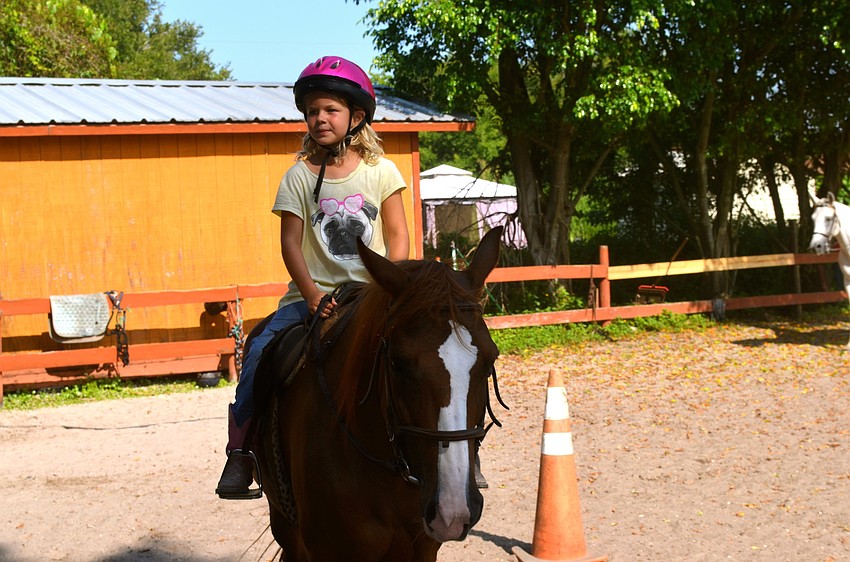 Grace Olesen shows off her horseback riding skills.