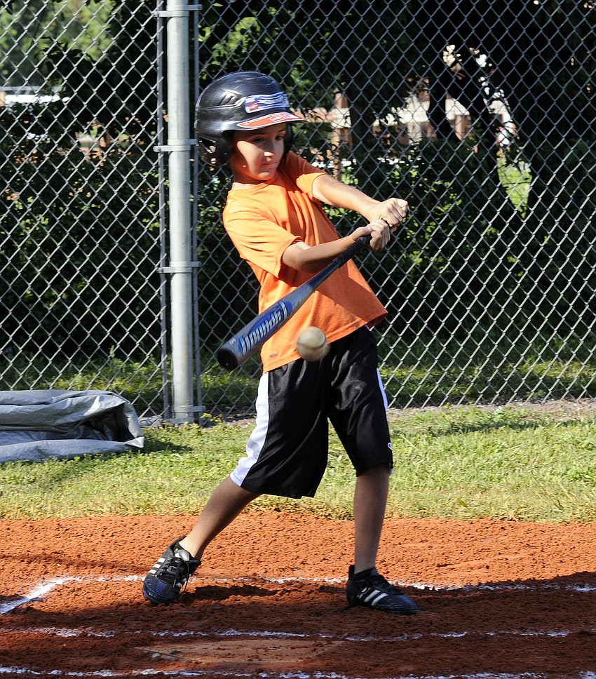 Eight-year-old Silas McKellar makes contact during his first at bat of the game.