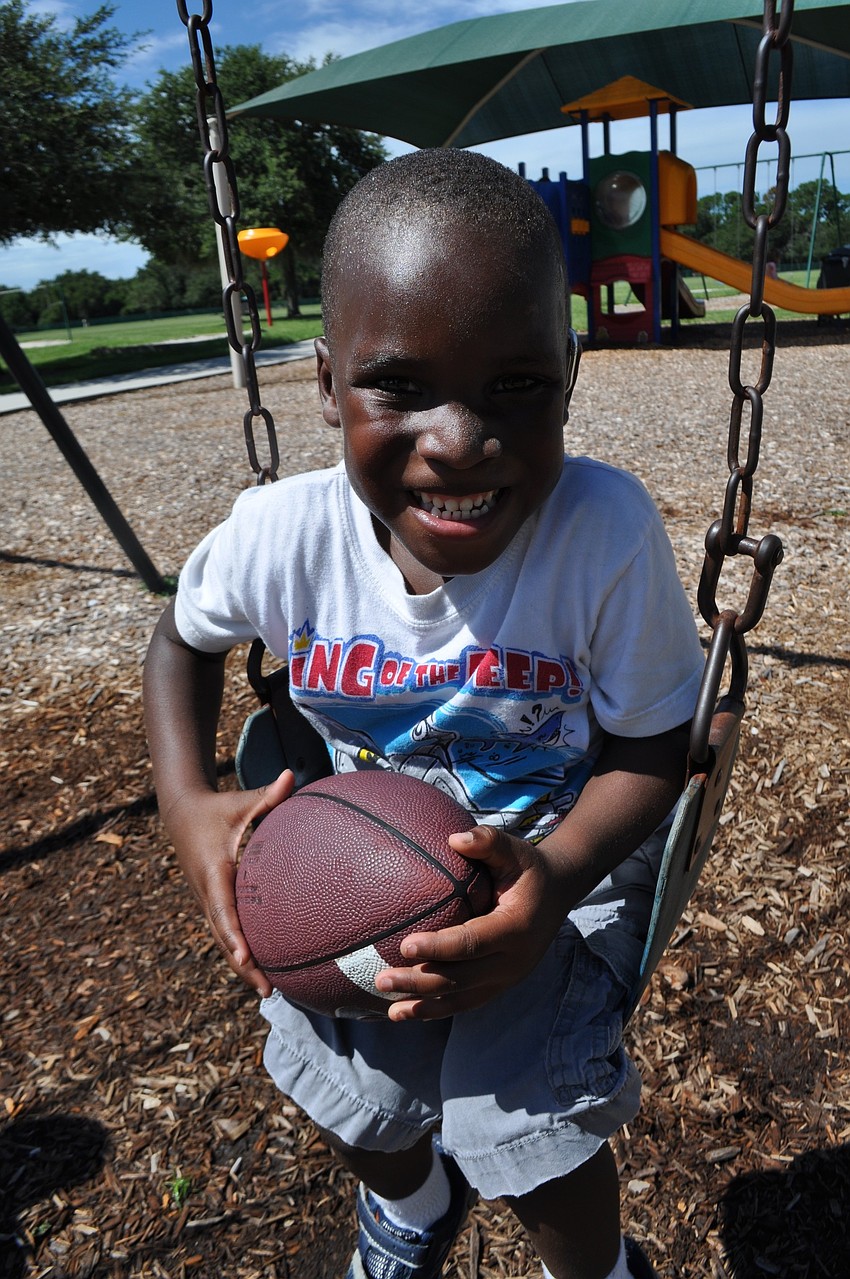 Joshua Ditzel, 3, brings his football to the playground.