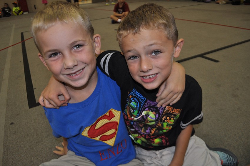 Enzo Knapp with Devin Allan visit while they wait for a game to start.