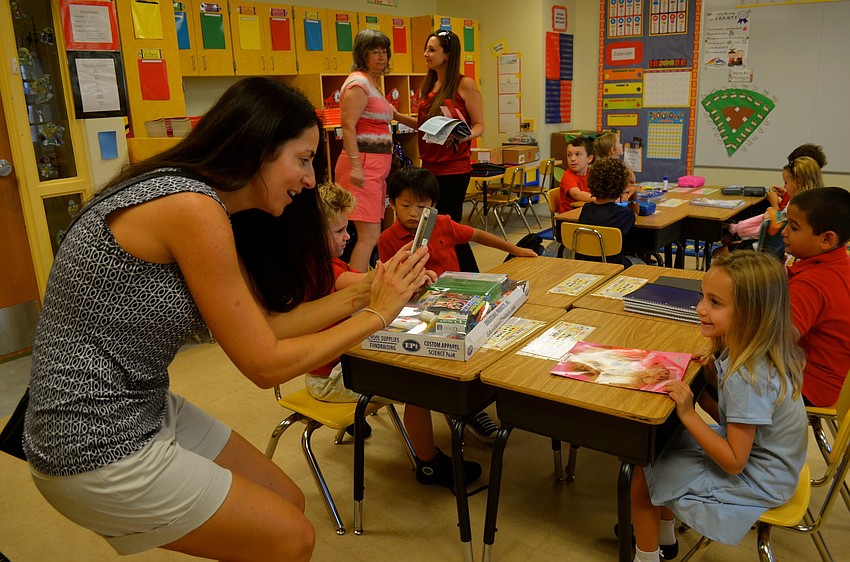 Charlotte Griffin takes a photo on her smartphone of her daughter, Maya.