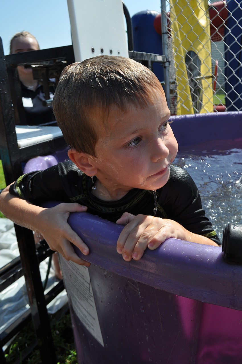 Jaxon Griffin, 4, emerges from the water after being dunked.