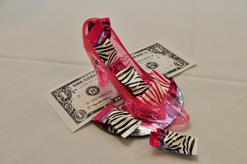 Decorating to the theme of the presentation, Chris Sancin decorated the table with high heels and dollar bills.