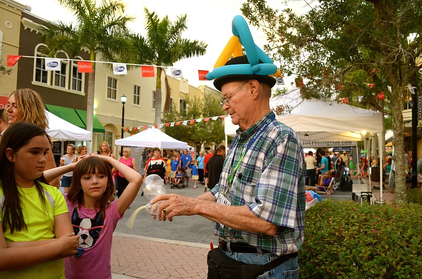 Stevie Dee makes balloon animals for excited children.
